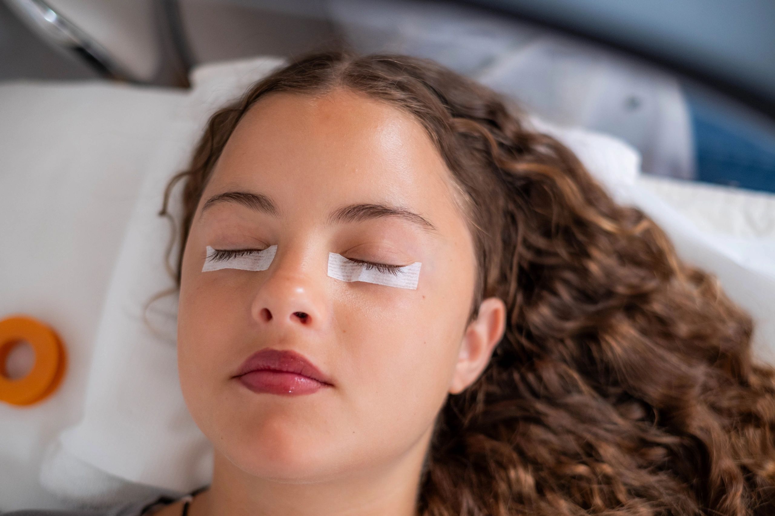 Esthetician applying eyelash extensions with precision