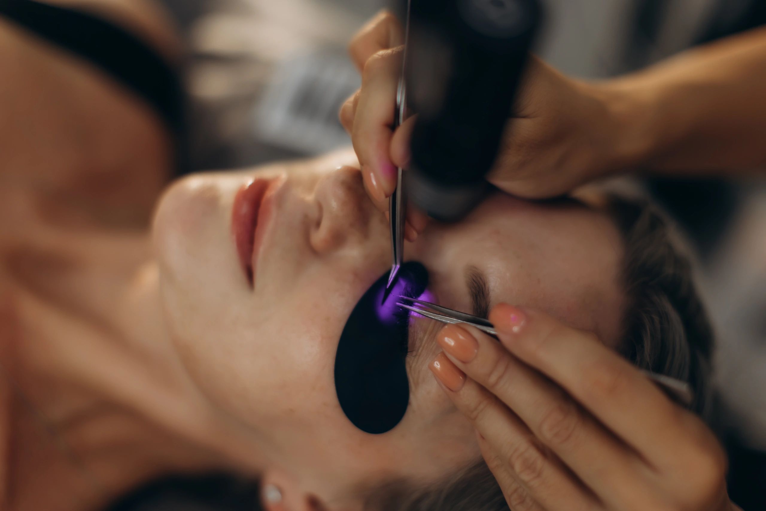Professional eyelash extension application in studio